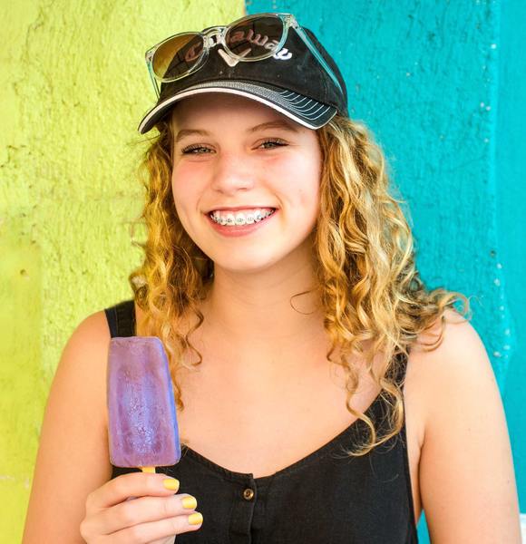 Girl with braces and purple ice cream